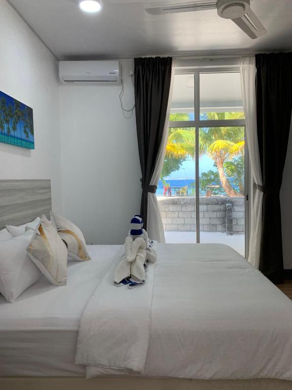 a teddy bear sitting on top of a bed at Villa Argento in Rimbudu
