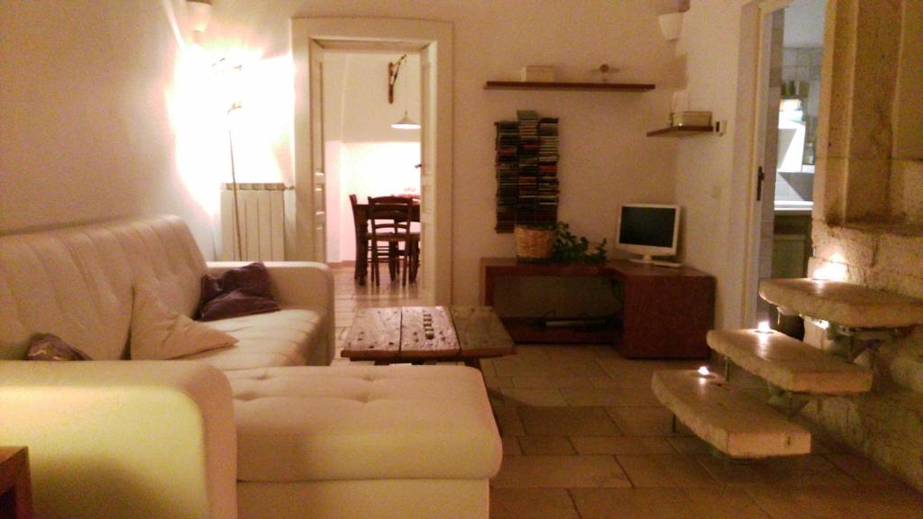 a living room with a couch and a table at Via Roma in Ostuni