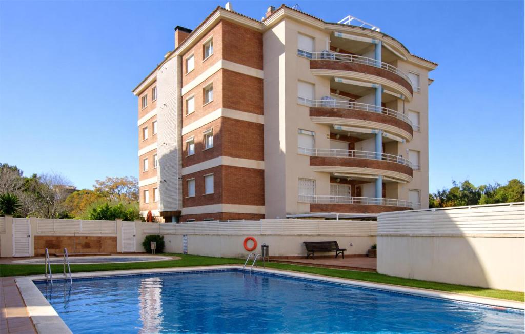 a building with a swimming pool in front of a building at Gorgeous Apartment In Calafell With Swimming Pool in Calafell