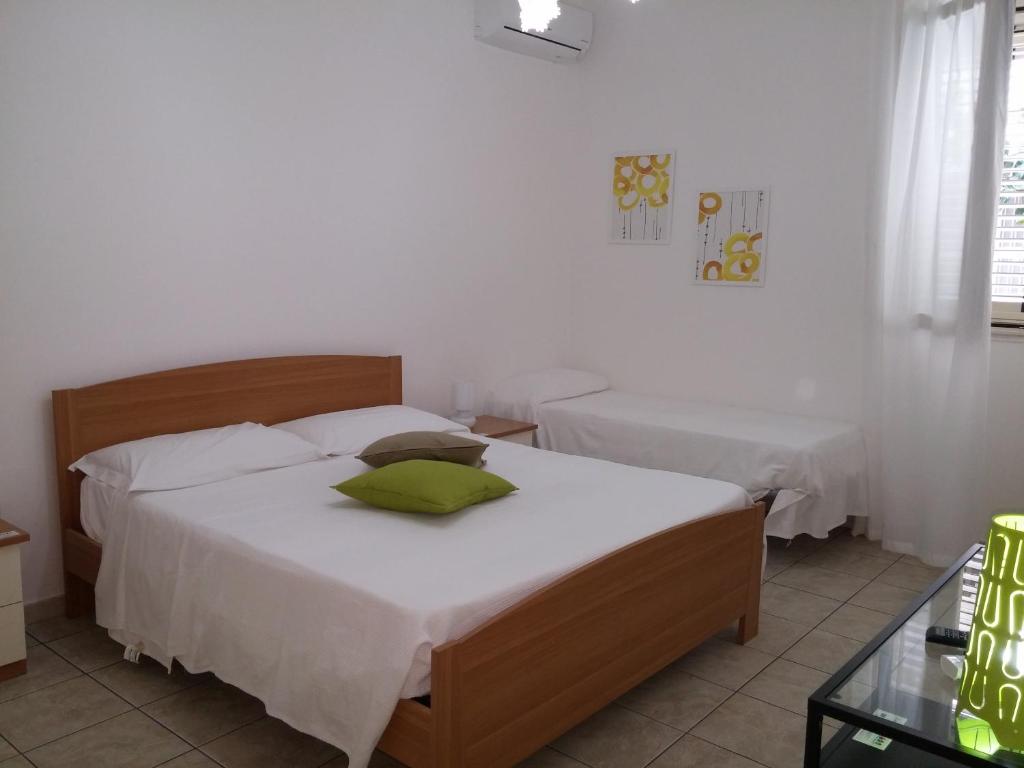 a bedroom with two beds and a glass table at Akron B&B in SantʼAlessio Siculo