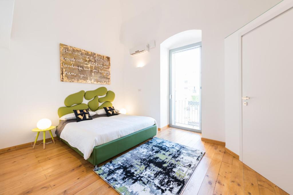 a bedroom with a bed and a rug at Art Loft M8 Bari City Centre in Bari