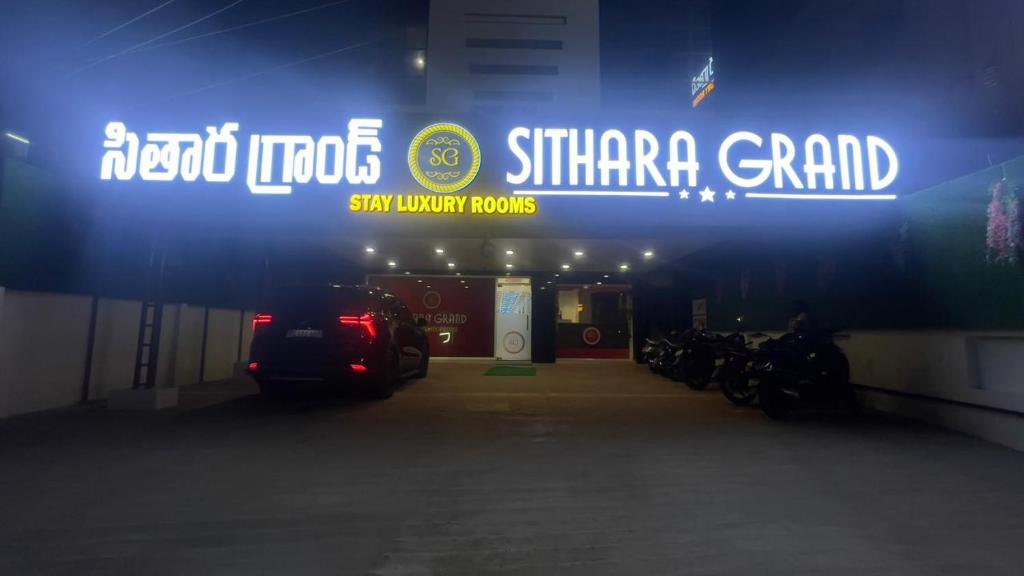 a garage with motorcycles parked under a sign at Sithara Grand in Ongole