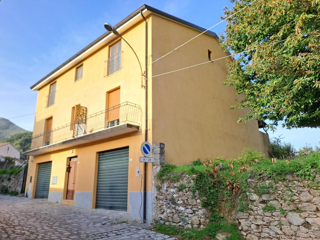 a yellow house on a cobblestone street at Casa di Biagio e Maria in Trecchina
