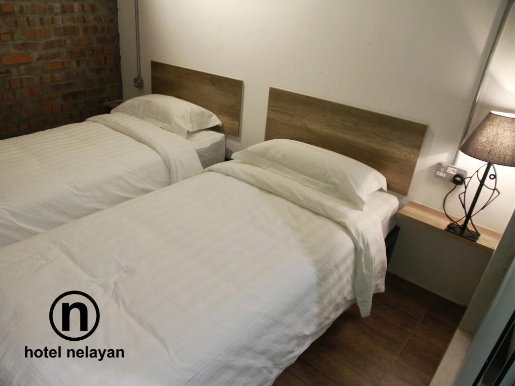 Postel nebo postele na pokoji v ubytování Hotel Nelayan