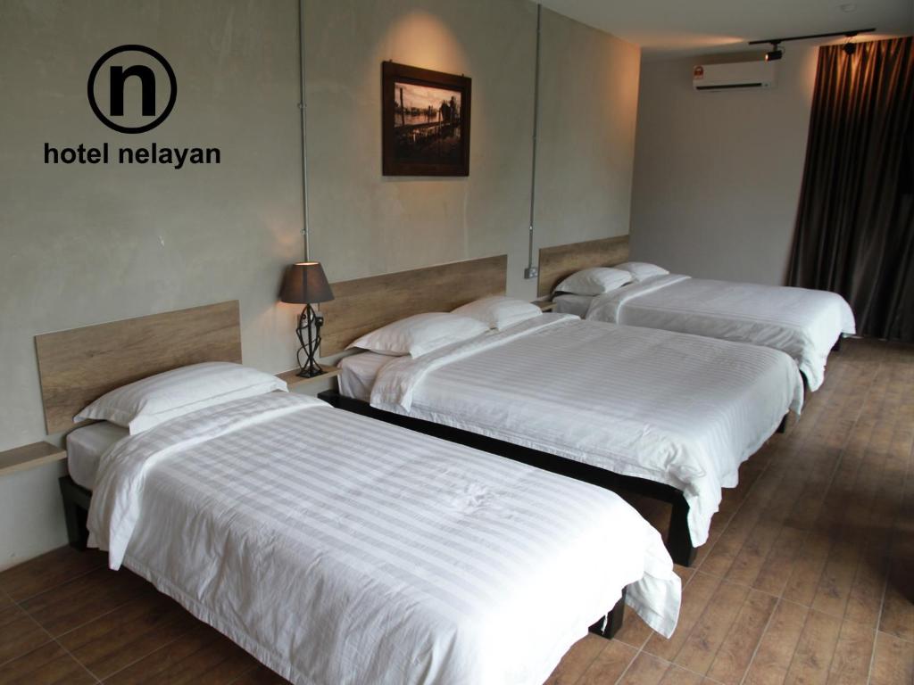 Postel nebo postele na pokoji v ubytování Hotel Nelayan