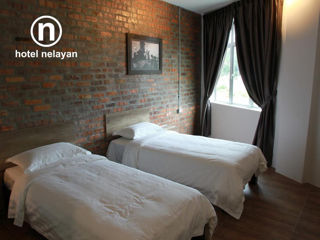 Postel nebo postele na pokoji v ubytování Hotel Nelayan