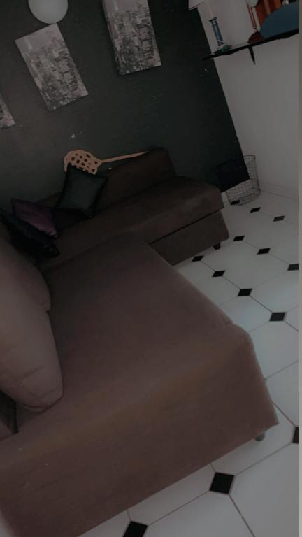 a living room with a couch and a chair at Rez chaussée transformé en t4 au 114 Avenue de juvisy cottages in Juvisy-sur-Orge