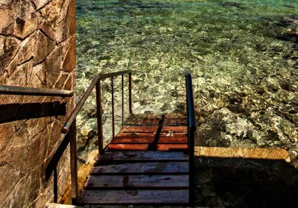 a stairway leading down to the beach with the water at Centrally located in Gaios