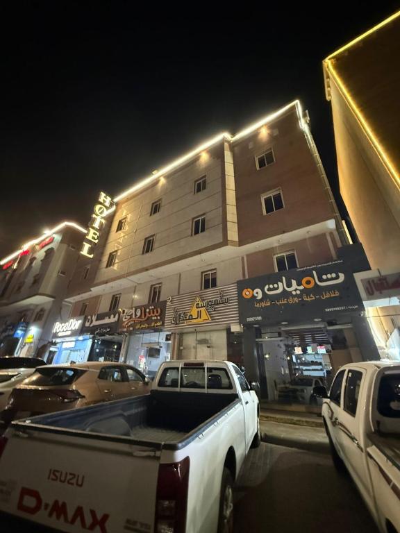 a white truck parked in front of a building at مساكن المبيت 5 new in Abha