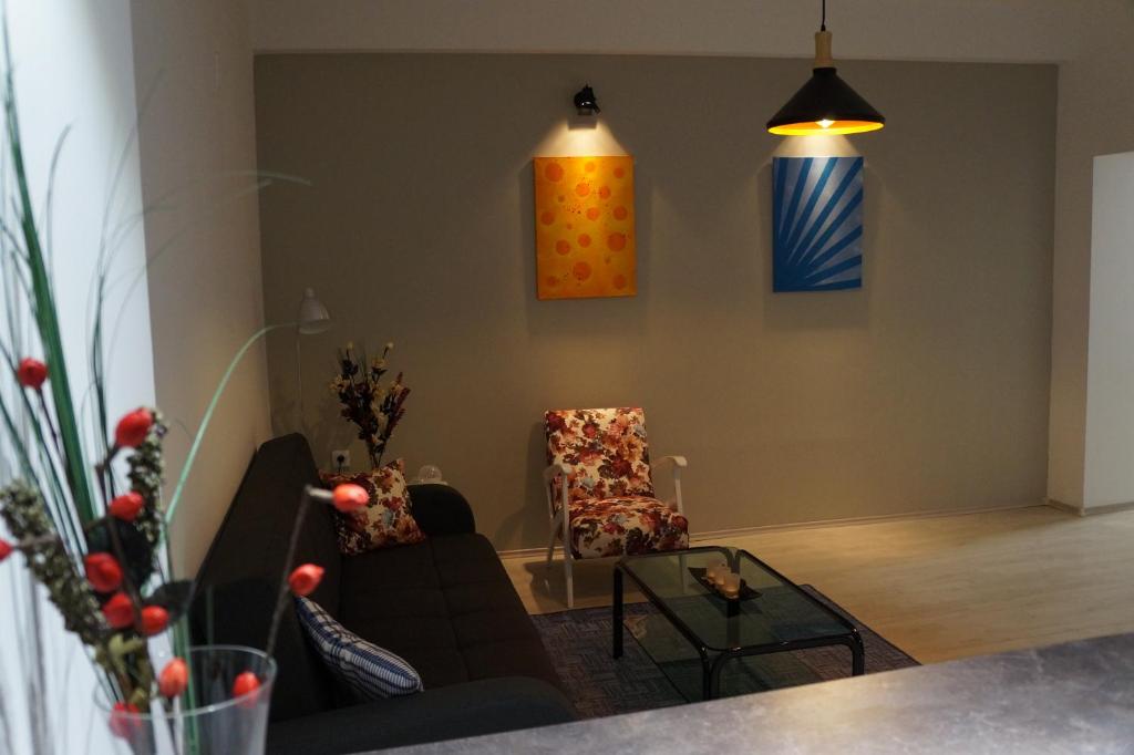 a living room with a couch and two chairs at Lazarus Apartment in Skopje