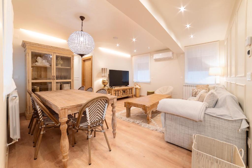 a living room with a table and a couch at Cangas de Onís CENTRO in Cangas de Onís