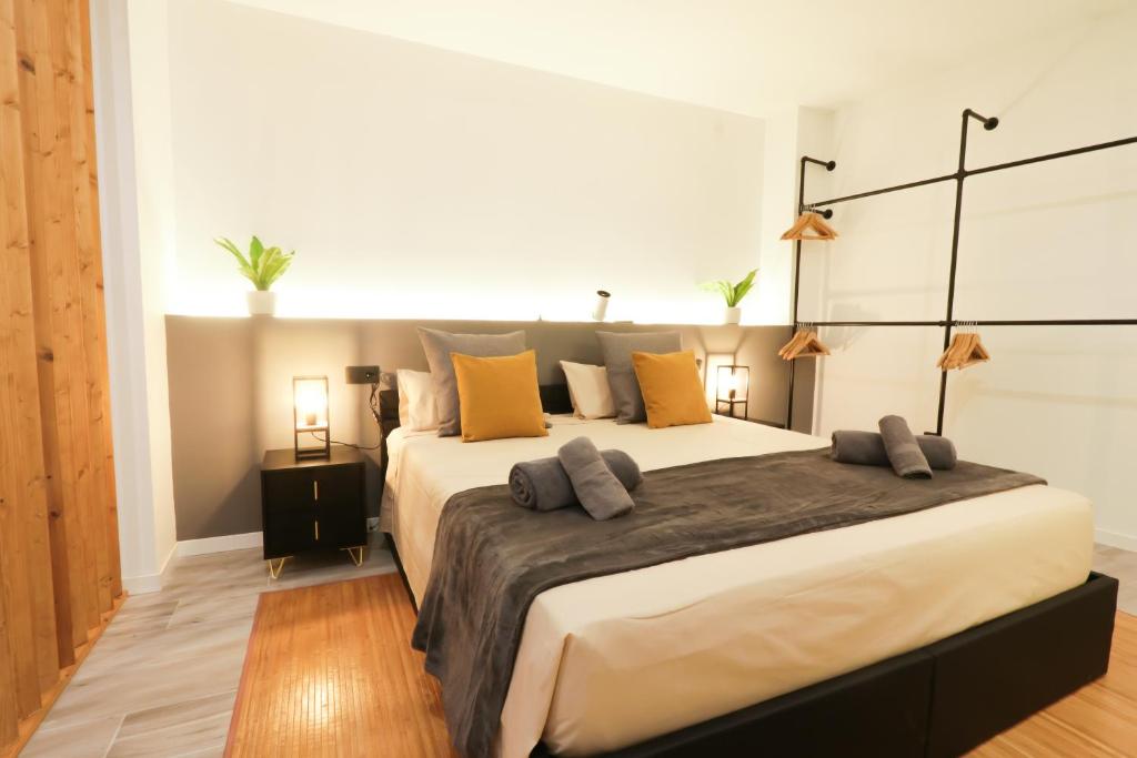 a bedroom with a large bed with pillows on it at Sweet Suites in Valencia
