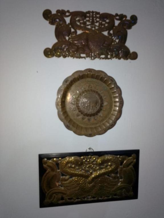 a gold plate hanging on a wall at Uswatta in Matara