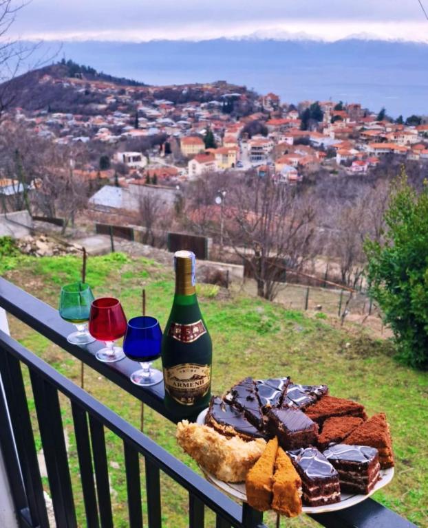 a table with a bottle of wine and chocolate desserts at Miriani - მირიანი in Sighnaghi