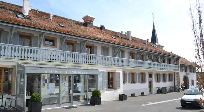 a large white building with a balcony on top of it at Auberge de Confignon in Geneva