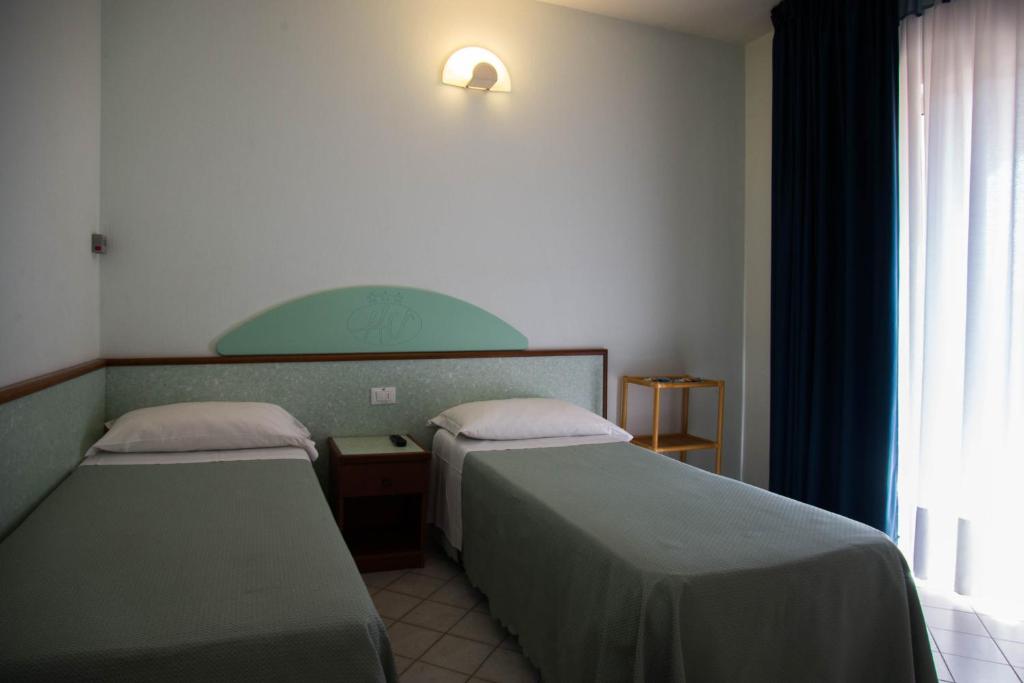 Postel nebo postele na pokoji v ubytování Hotel Gli Ulivi