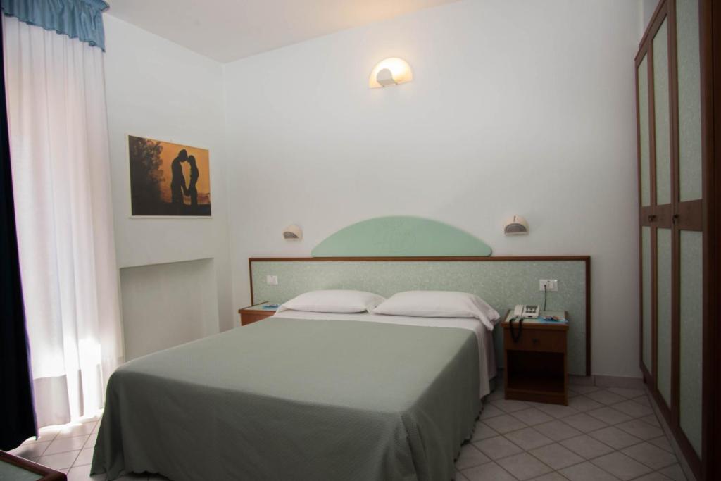 Postel nebo postele na pokoji v ubytování Hotel Gli Ulivi