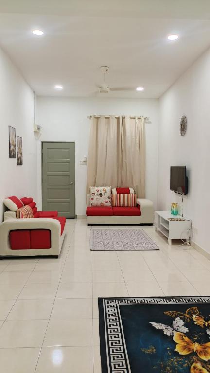 a living room with two beds and a couch at NJAZ Homestay Perlis in Arau