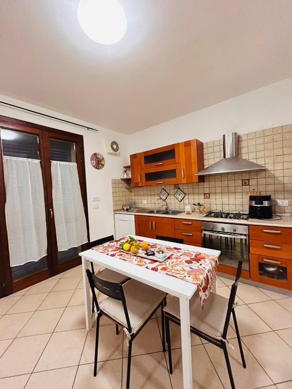 a kitchen with a white table and chairs in a room at Elisabeth home in Modica