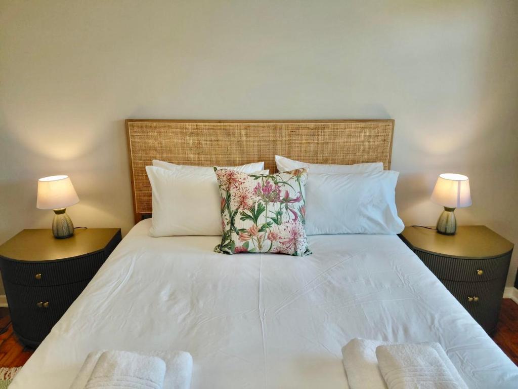 a bedroom with a bed with two lamps on both sides at The Botanic Venus in Paarl