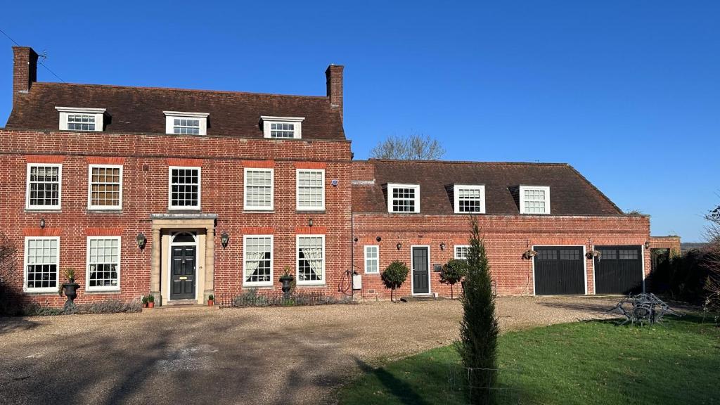 a large red brick building with white windows at The Coach House WPH, Epping in Epping