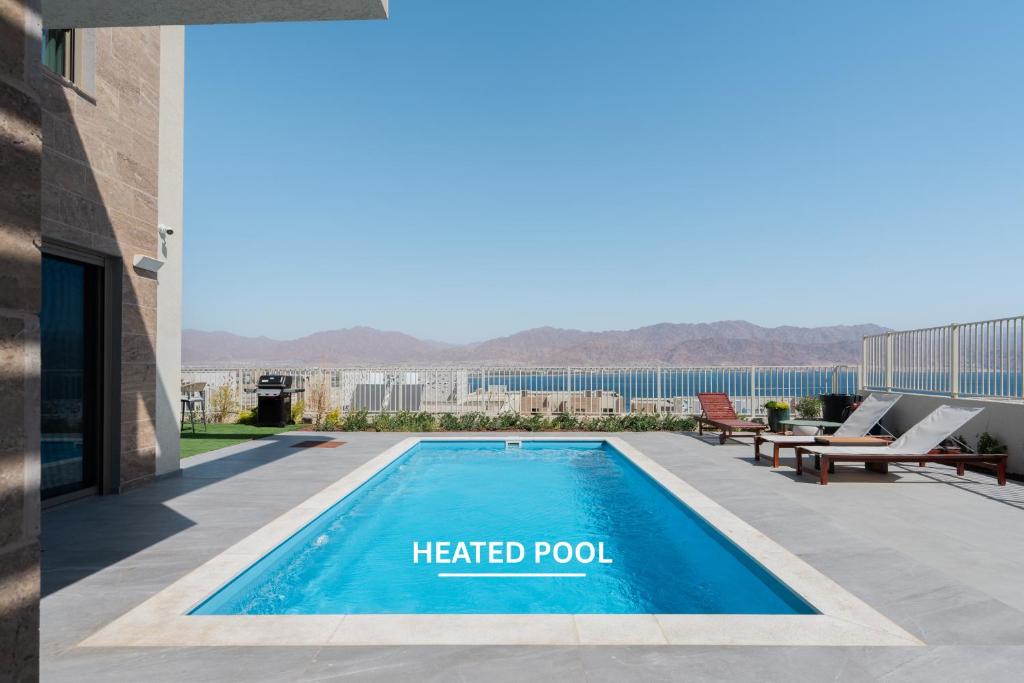 a heated pool on the roof of a building at Villa Dekel - By Harim in Eilat