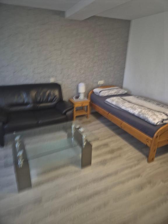 a toy room with a bed and a couch at Monteurzimmer 1 in Frielendorf