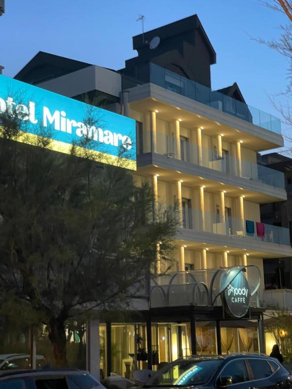 a building with a sign that reads hotel millennium at Hotel Miramare in Sottomarina