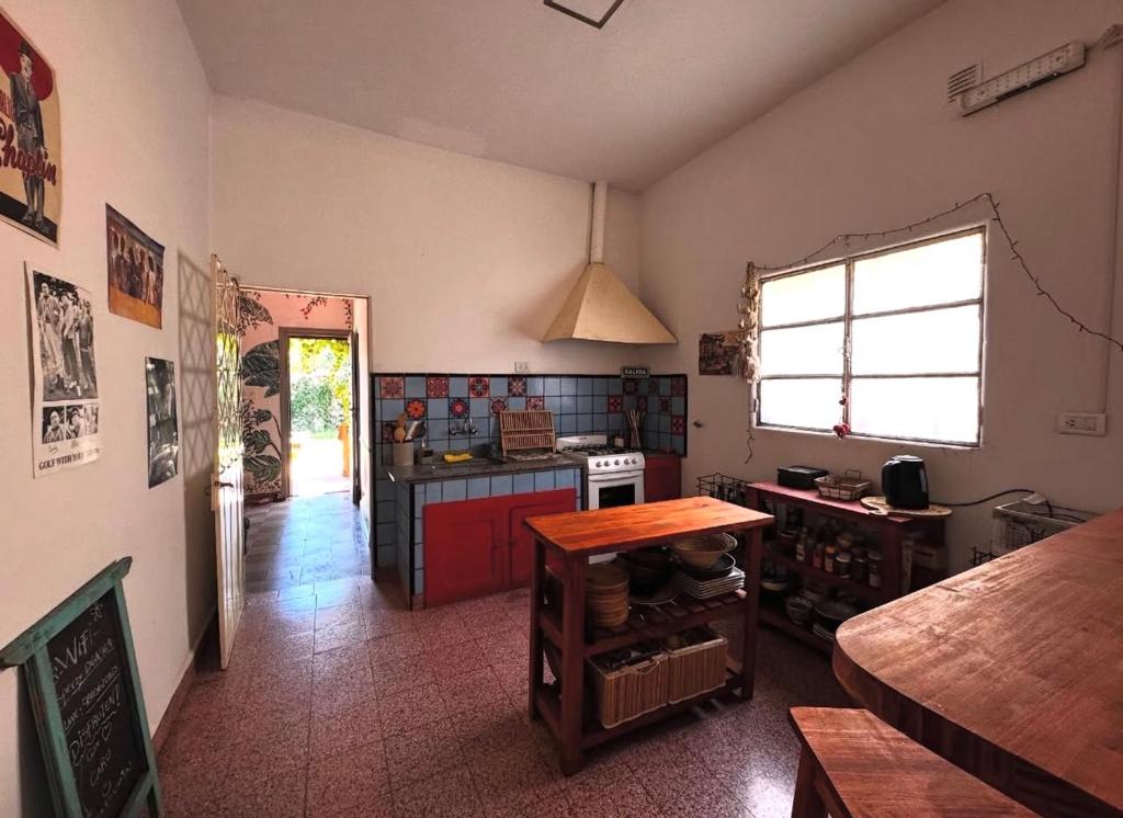 a kitchen with a counter and a table in it at Casita Eureka in San Antonio de Areco