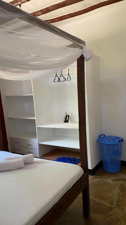 a bedroom with a bunk bed and a shelf at 2 Bedroom serene cottage in Ukunda Airport