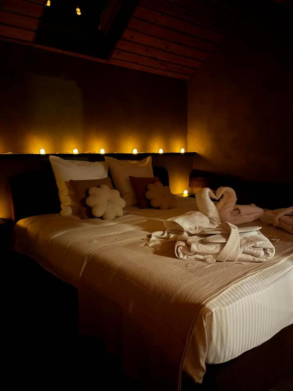 a bedroom with a large bed with towels on it at Suite Sur Le Mont in Durbuy