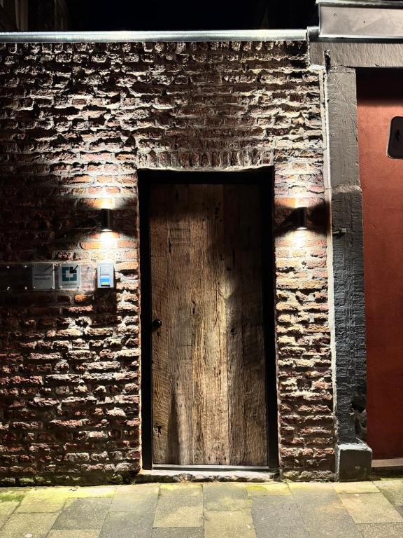 a wooden door on a brick wall at accademia00 in Maastricht