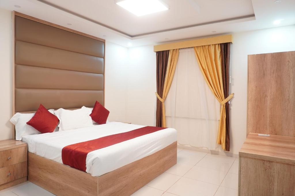 a bedroom with a bed and a television at Dyar Sultana - 10 Mins Drive to Al Masjed Al Nabwi in Sulţānah