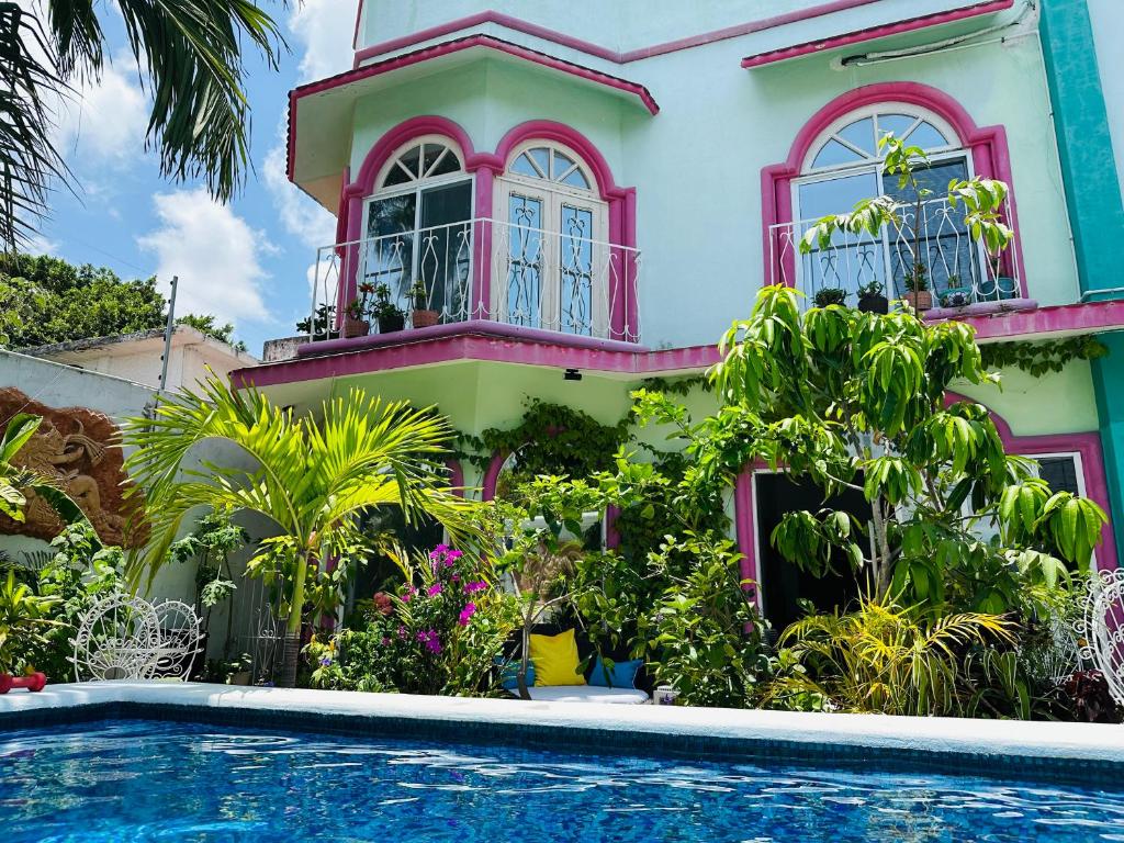 a house with a swimming pool in front of it at The Quetzal in Cancún