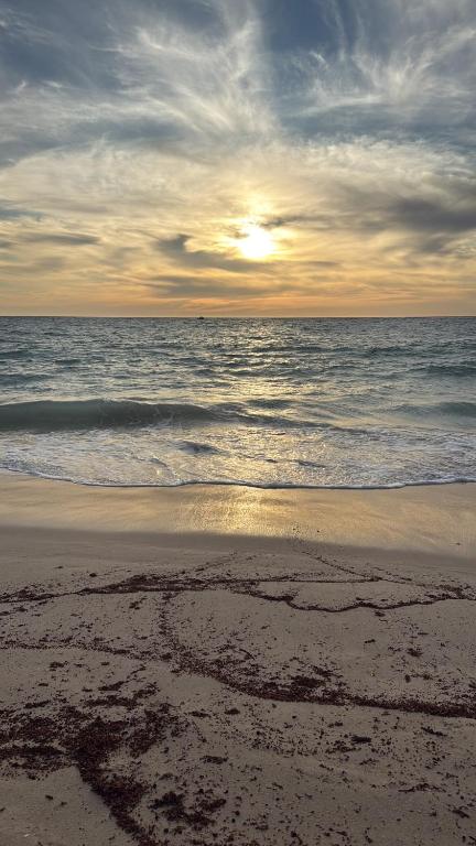 a heart drawn in the sand on the beach at Beach House Shared in Alkimos