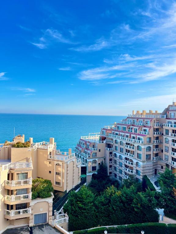 a group of buildings with the ocean in the background at La Mer Prime Time in Varna City