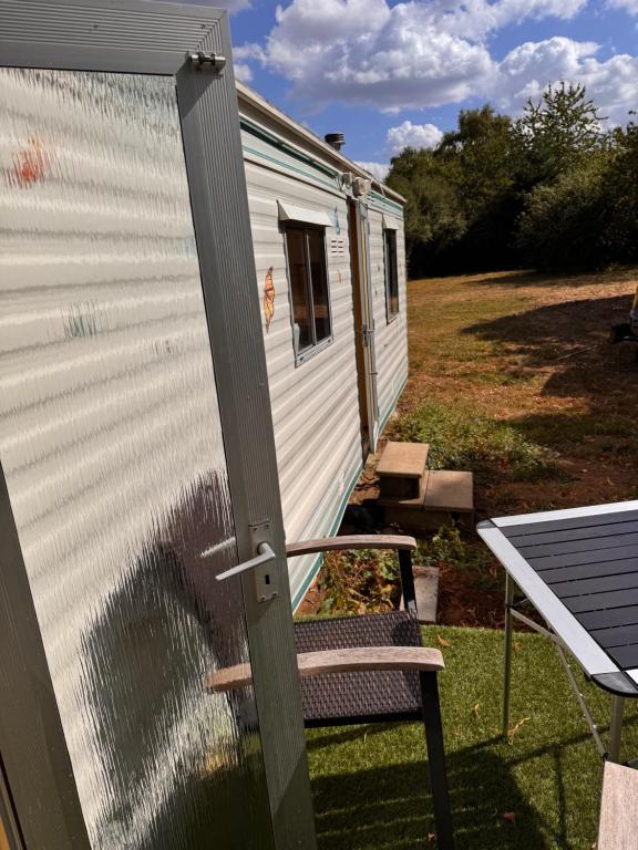 a dog looking out the window of a tiny house at Le joli centre energetique in Châteaumeillant