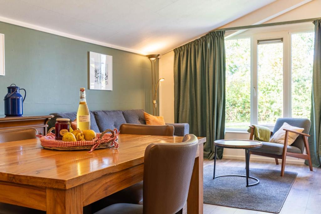 a living room with a table with a bottle of champagne at Studio Kweepeer in Ruinerwold