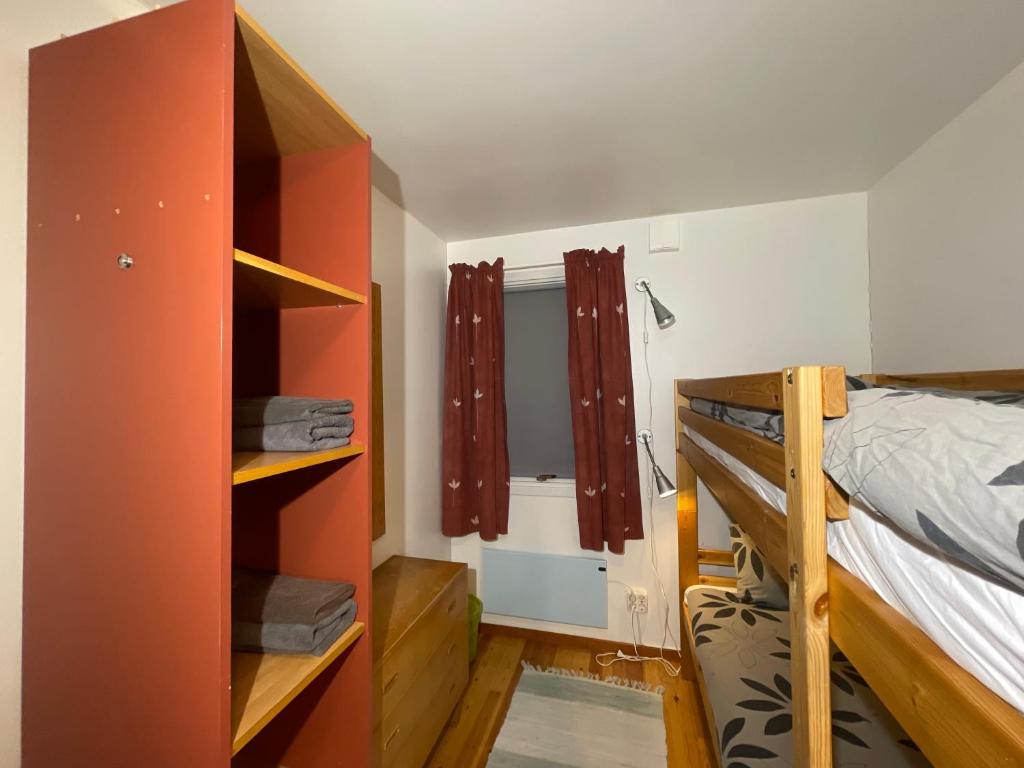 a bedroom with a bunk bed and a bunk room with a window at Laplanders room 2 in Kiruna
