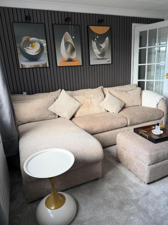 a living room with a couch and a table at Nessy5 Apartment in Inverness