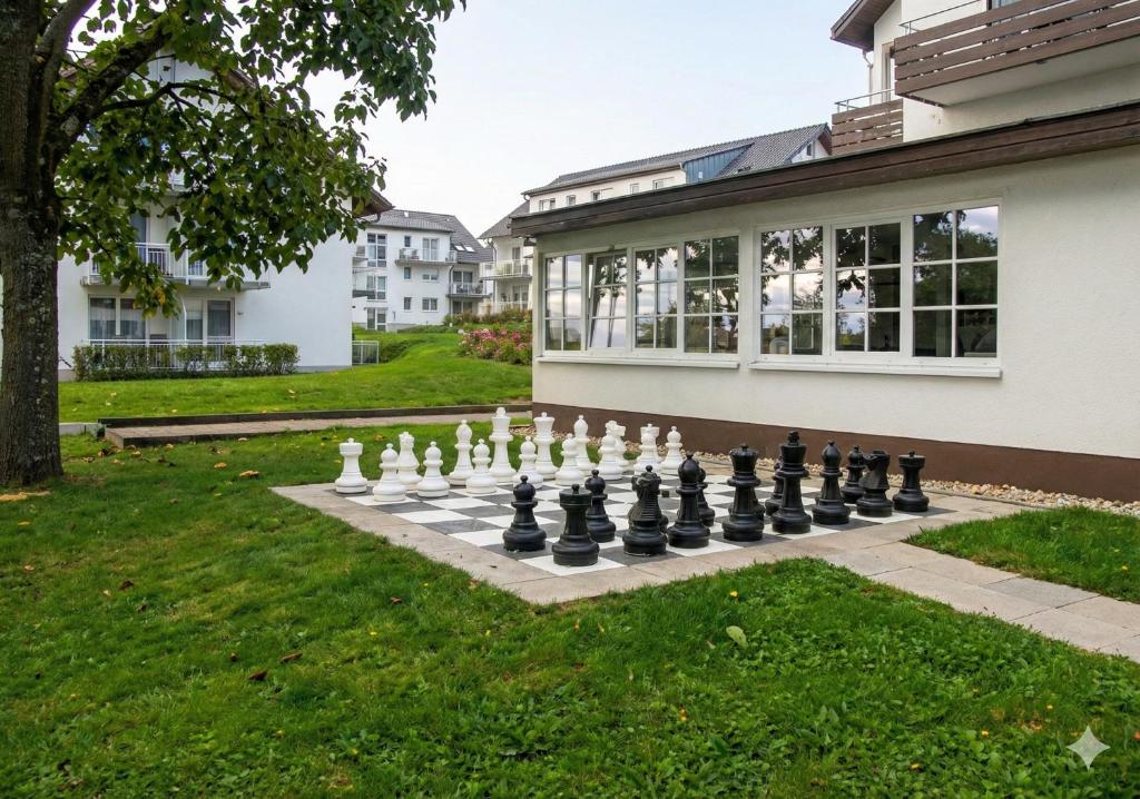 a giant chessboard on a lawn in front of a house at Hotel Hebelhof in Bad Bellingen
