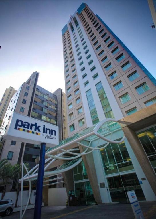 a park inn sign in front of a building at Radisson Berrini Suite executiva Luxo Queen in São Paulo