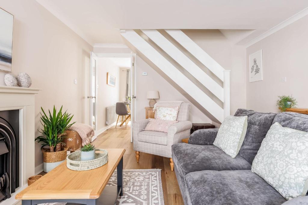 a living room with a couch and a chair at Edward Cottage - Old Town Poole Home, Moments from Poole Quay in Poole