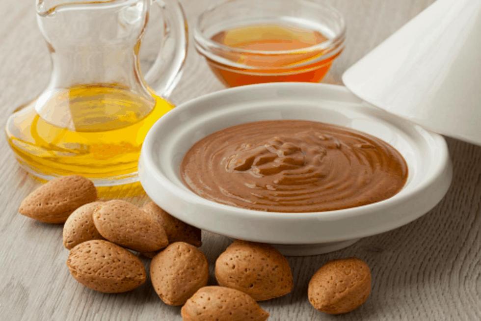 a bowl of peanut butter and a jug of honey at Charmante Villa Traditionnelle in Marrakesh
