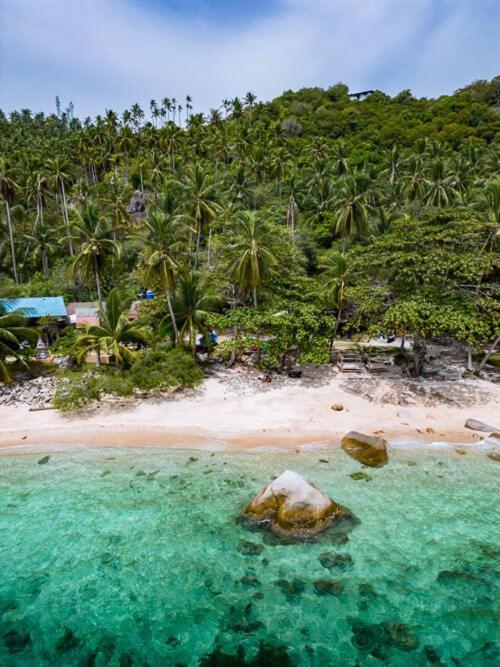 an aerial view of a beach with a rock in the water at Bird Nest in Ko Tao
