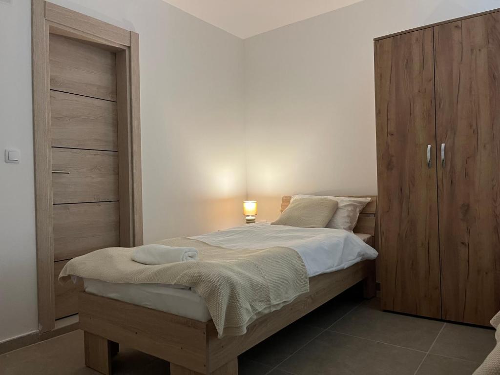 a bedroom with a bed and a wooden cabinet at Etno kuca Brzece in Brzeće