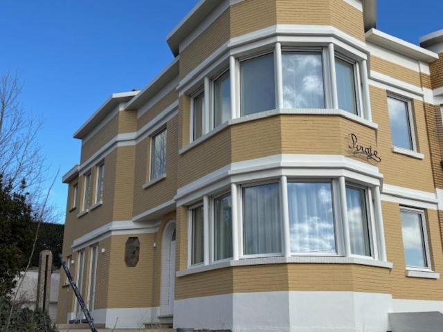 a tall building with many windows on the side of it at Pirate, op 100 meter van strand in Koksijde