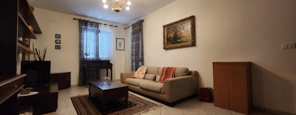 a living room with a couch and a picture on the wall at La Casa delle Liane in Galatina