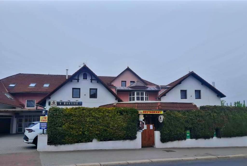a house with a car parked in front of it at Penzion u Martina in Liberec