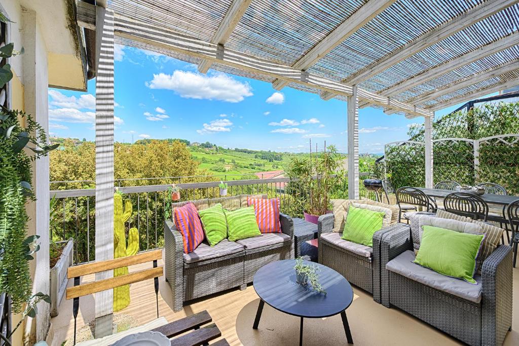 a patio with couches and a table with a view at Casamia Tuscan Oasis 4Br Panoramic Penthouse Hot Tub & Easy Parking in Siena